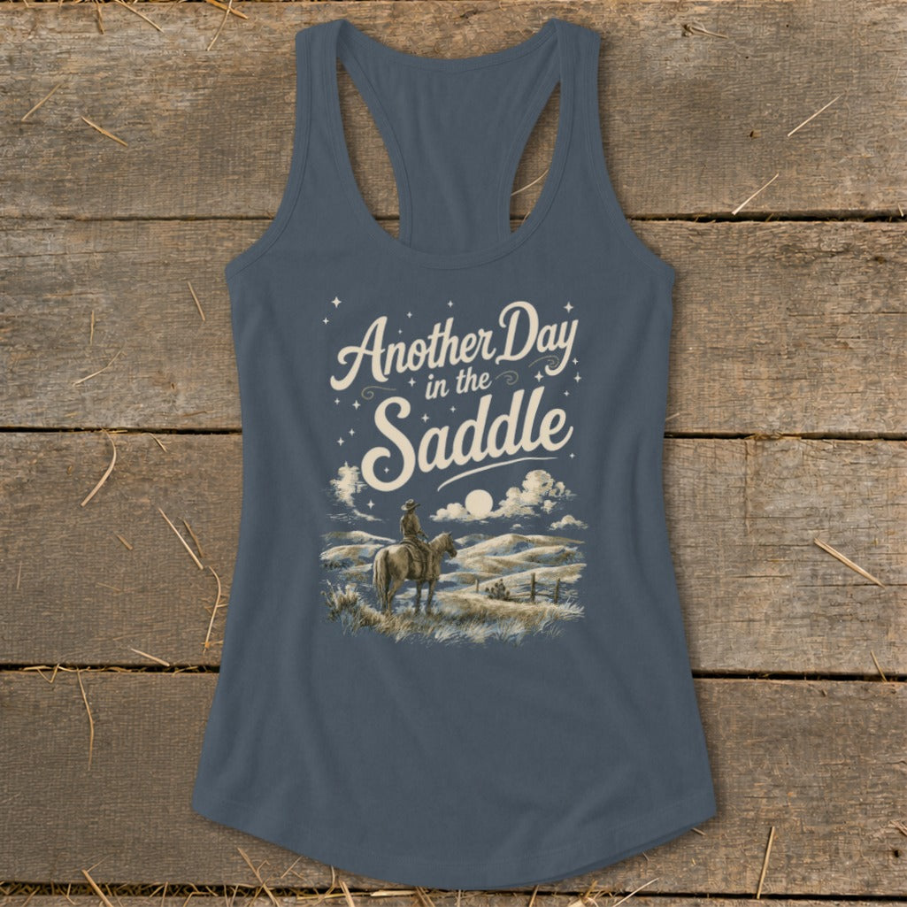 Tank top with "Another Day in the Saddle" text and a cowboy on horseback.