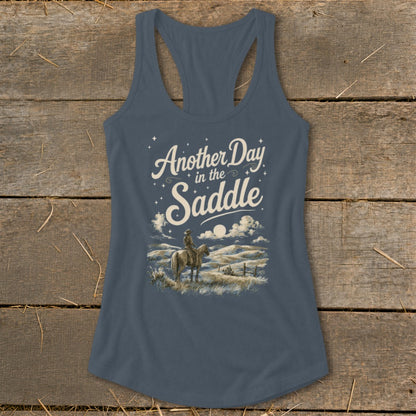 Tank top with "Another Day in the Saddle" text and a cowboy on horseback.