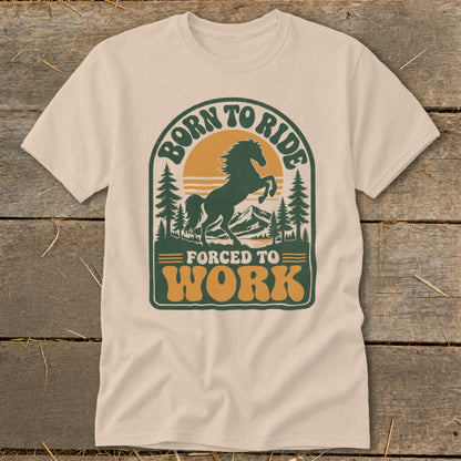 T-shirt graphic with a horse, mountains, trees, and text "Born to Ride Forced to Work".