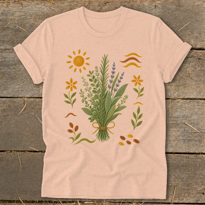 Peach t-shirt with embroidered bouquet of herbs, flowers, sun, and abstract shapes.