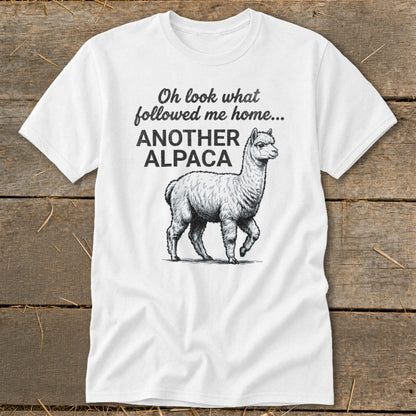 White t-shirt with "Oh look what followed me home... ANOTHER ALPACA" and alpaca graphic.