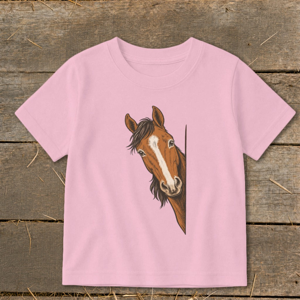 Pink t-shirt with a drawing of a brown horse peeking from the side.