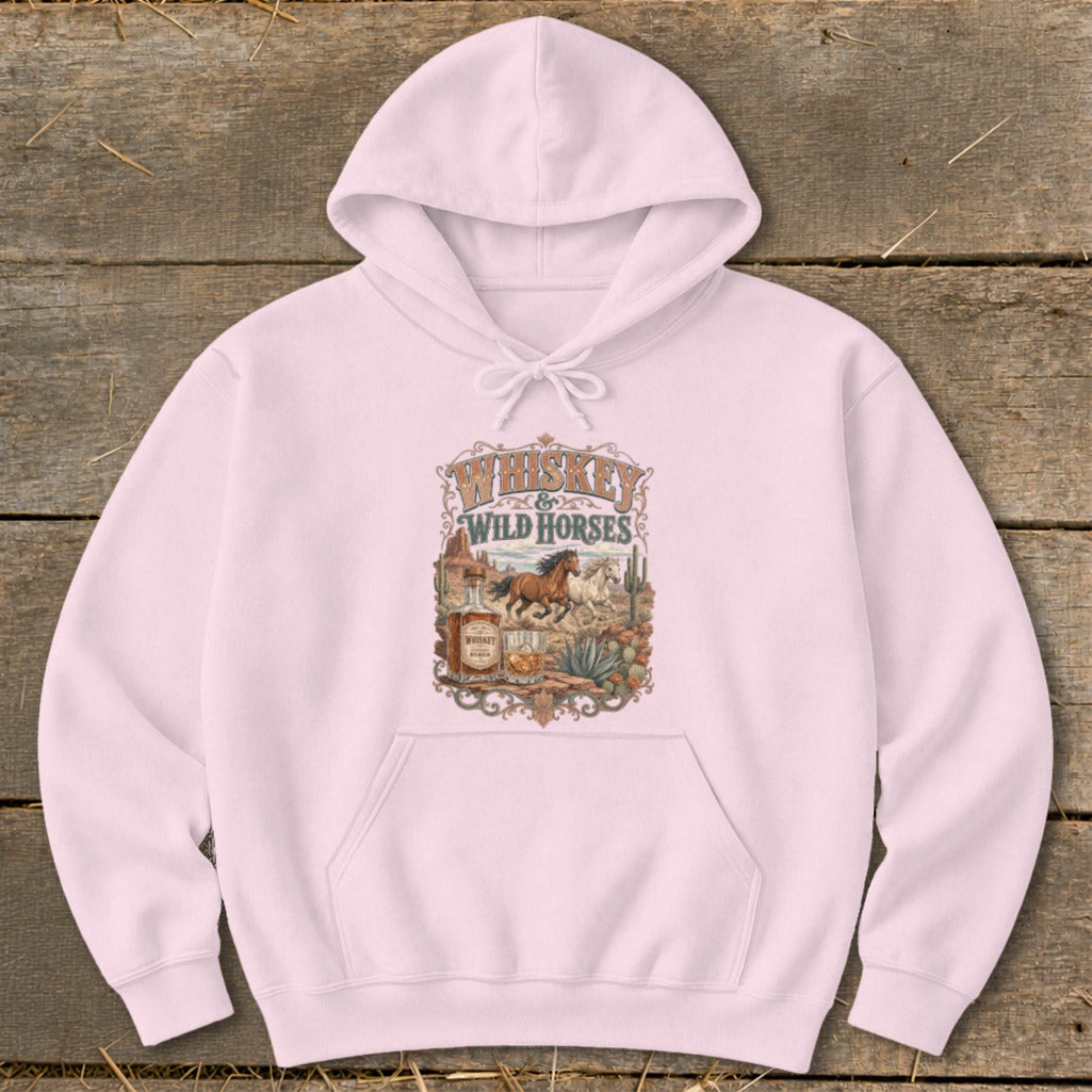 Pink hoodie with "Whiskey & Wild Horses" graphic of horses, desert, and whiskey bottle.