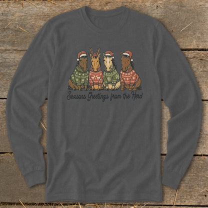 Four horses in Christmas sweaters and Santa hats with "Seasons Greetings from the Herd."