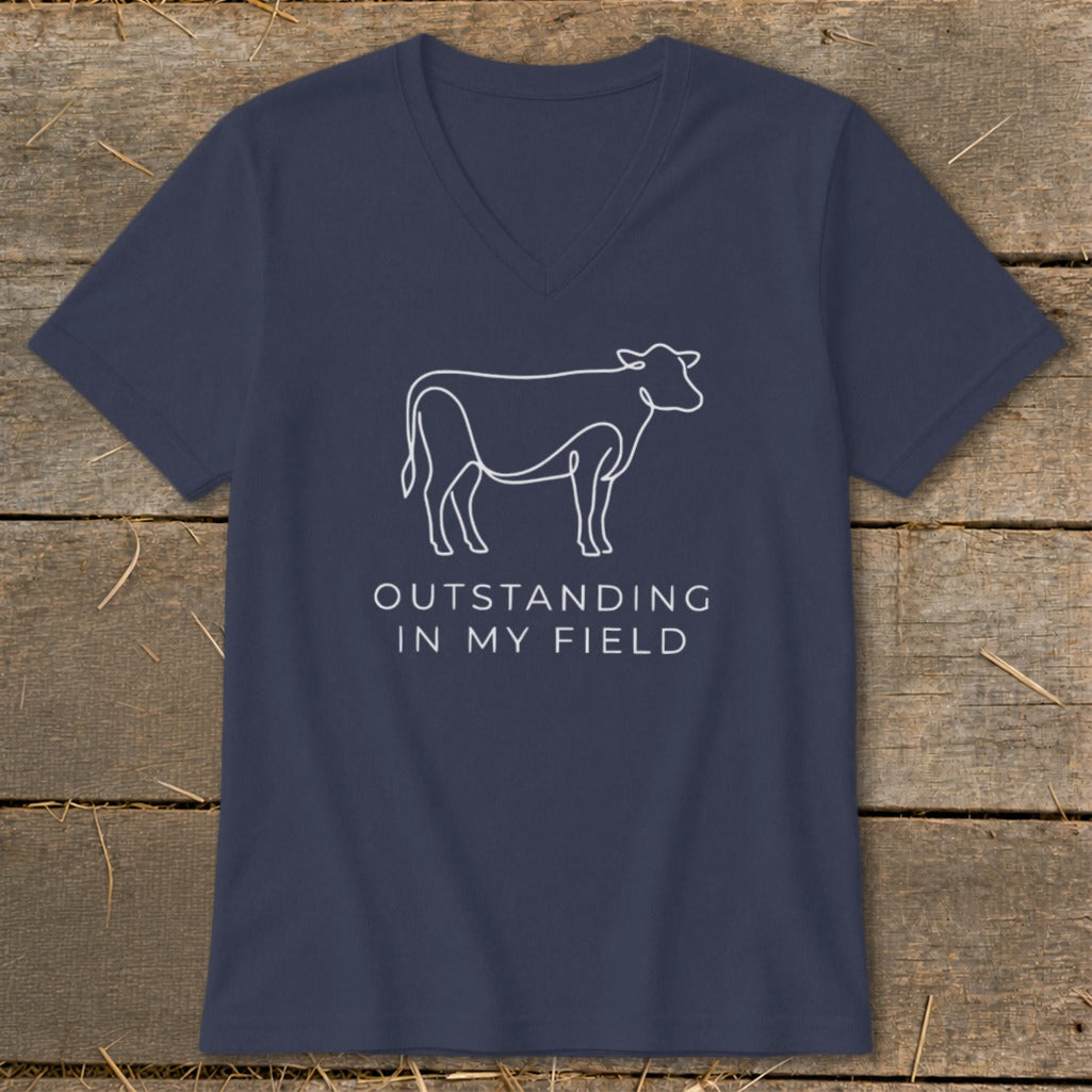 Navy v-neck t-shirt with white line drawing of a cow and text: "OUTSTANDING IN MY FIELD".