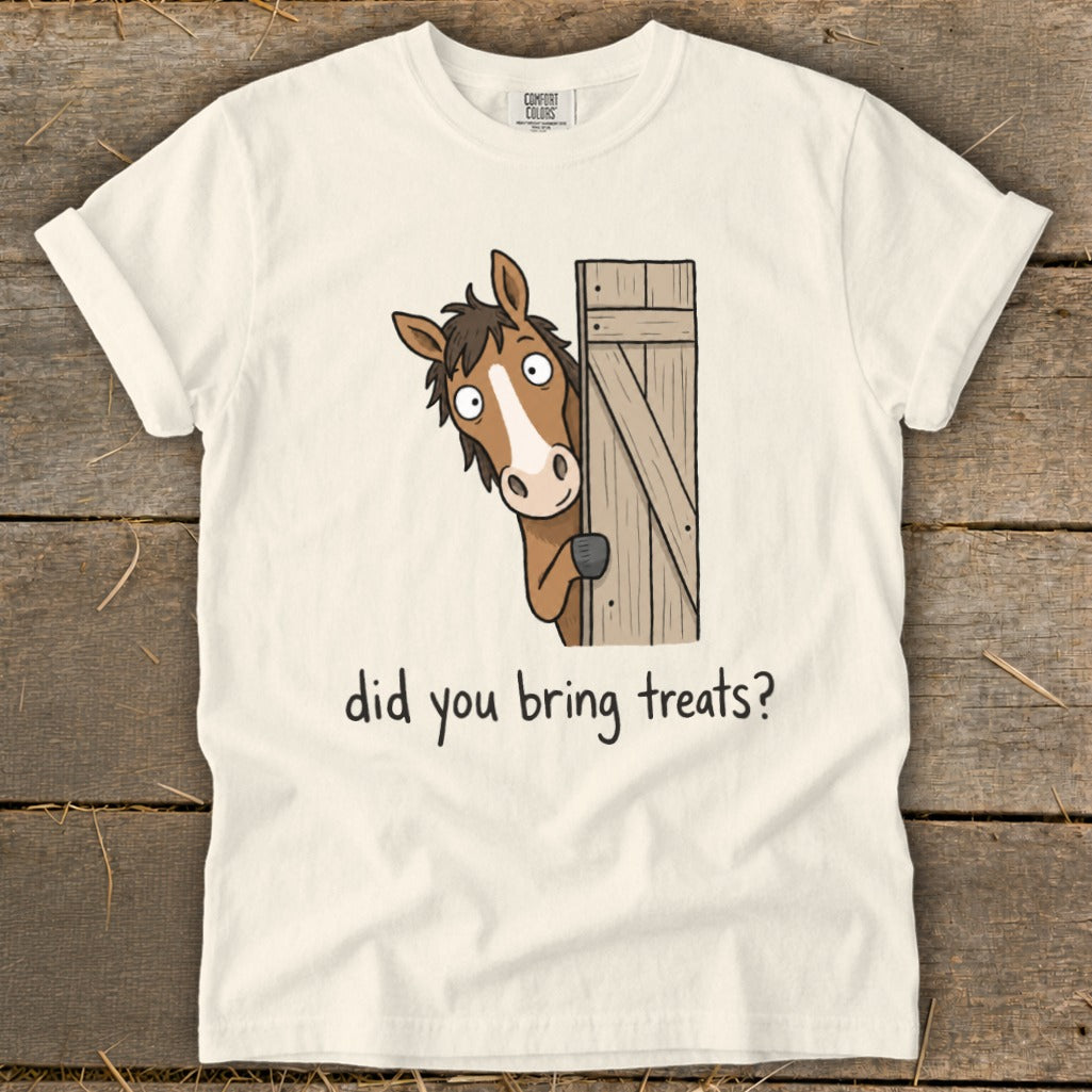 Cream t-shirt with a cartoon horse peeking from behind a wooden fence asking "did you bring treats?".
