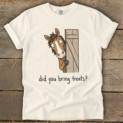Cream t-shirt with a cartoon horse peeking from behind a wooden fence asking "did you bring treats?".