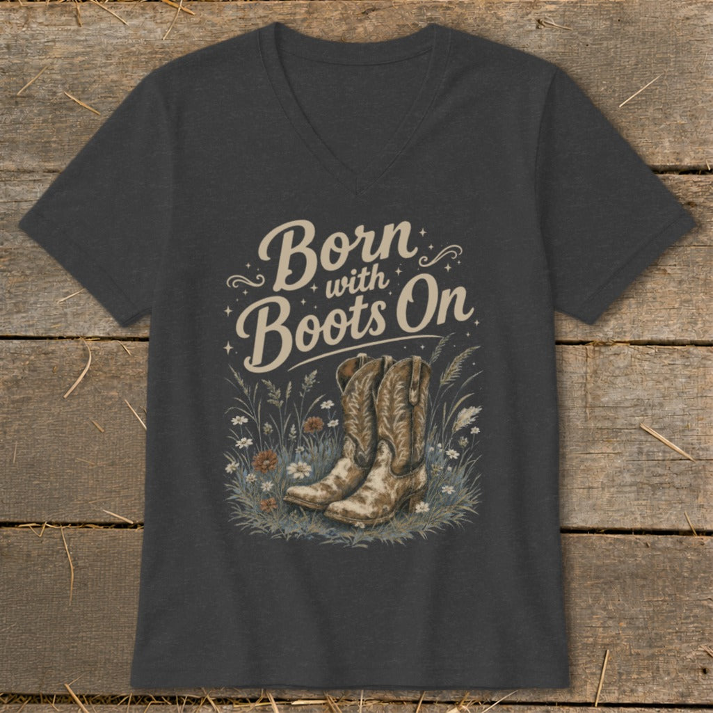 Dark grey v-neck t-shirt with "Born with Boots On" text and cowboy boots in grass.