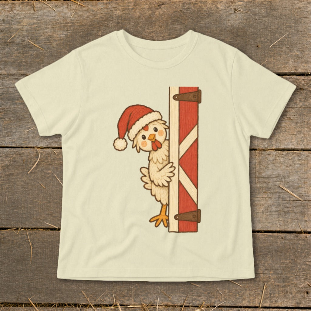 Cream t-shirt with a cartoon chicken wearing a Santa hat peeking around a barn door.