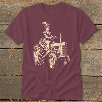 Vintage illustration of a woman in a fancy dress driving a tractor on a maroon t-shirt.