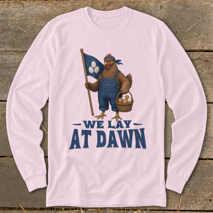 Chicken in overalls holding flag and basket of eggs with text "WE LAY AT DAWN".