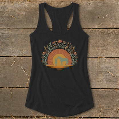 Black tank top with sunset, wildflowers, girl, and horse graphic.