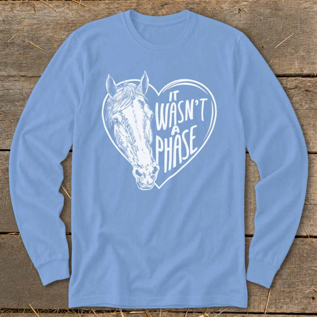 Light blue long sleeve shirt with white horse head inside a heart saying "It Wasn't A Phase".