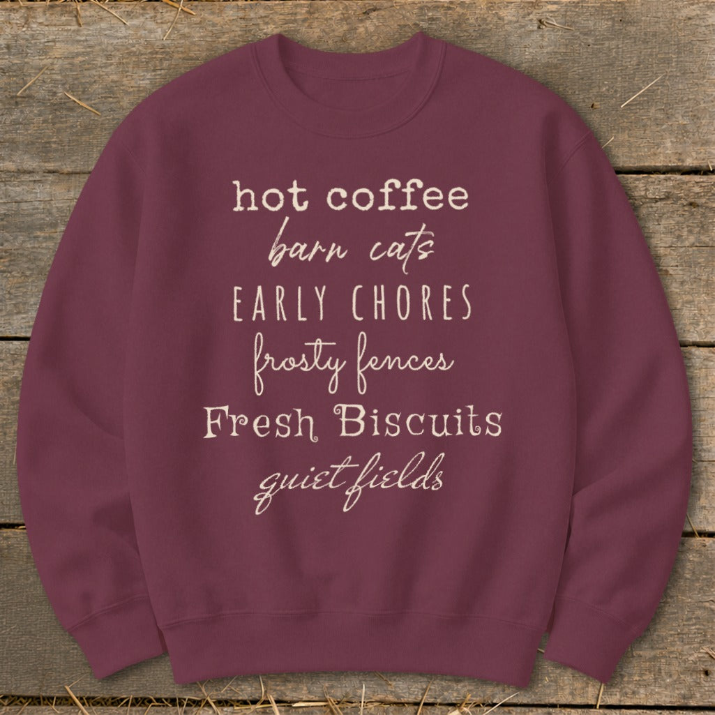 Maroon sweatshirt with text: "hot coffee barn cats EARLY CHORES frosty fences Fresh Biscuits quiet fields"
