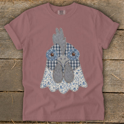 Rose t-shirt with a fabric applique of a chicken's face with blue gingham and floral patterns.
