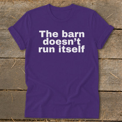 Purple t-shirt with white text "The barn doesn't run itself".