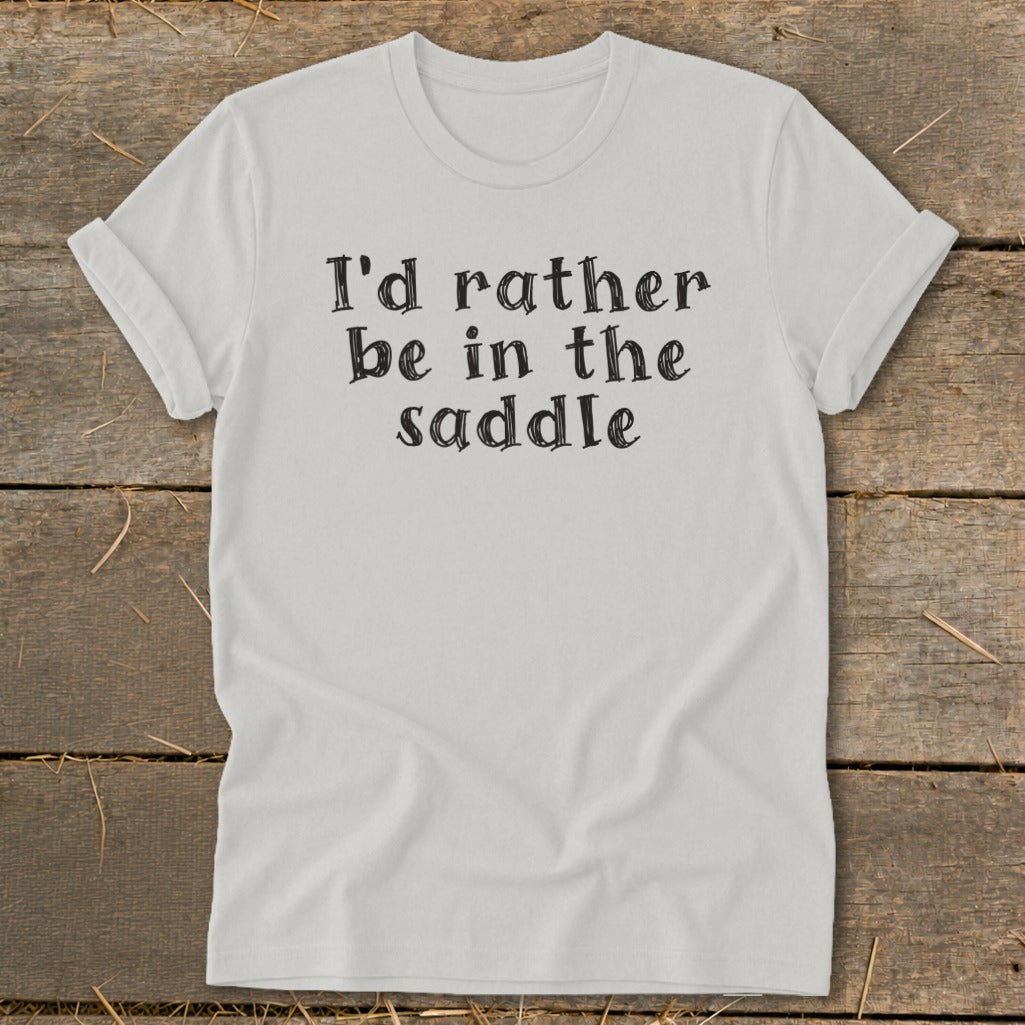 Light grey t-shirt with black text "I'd rather be in the saddle."