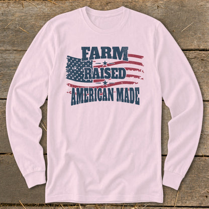 Pink long-sleeve shirt with distressed "FARM RAISED AMERICAN MADE" text over an American flag.