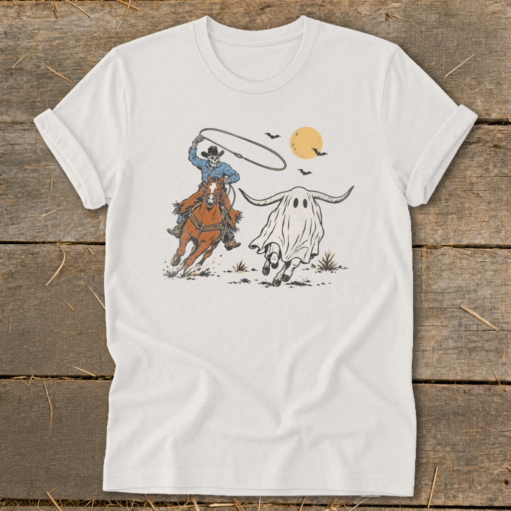 Skeleton cowboy on horse lassos a longhorn ghost under a full moon.