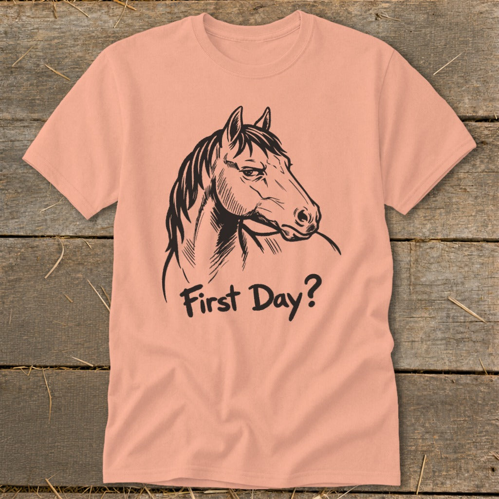 Peach t-shirt with black line art horse head and "First Day?" text.