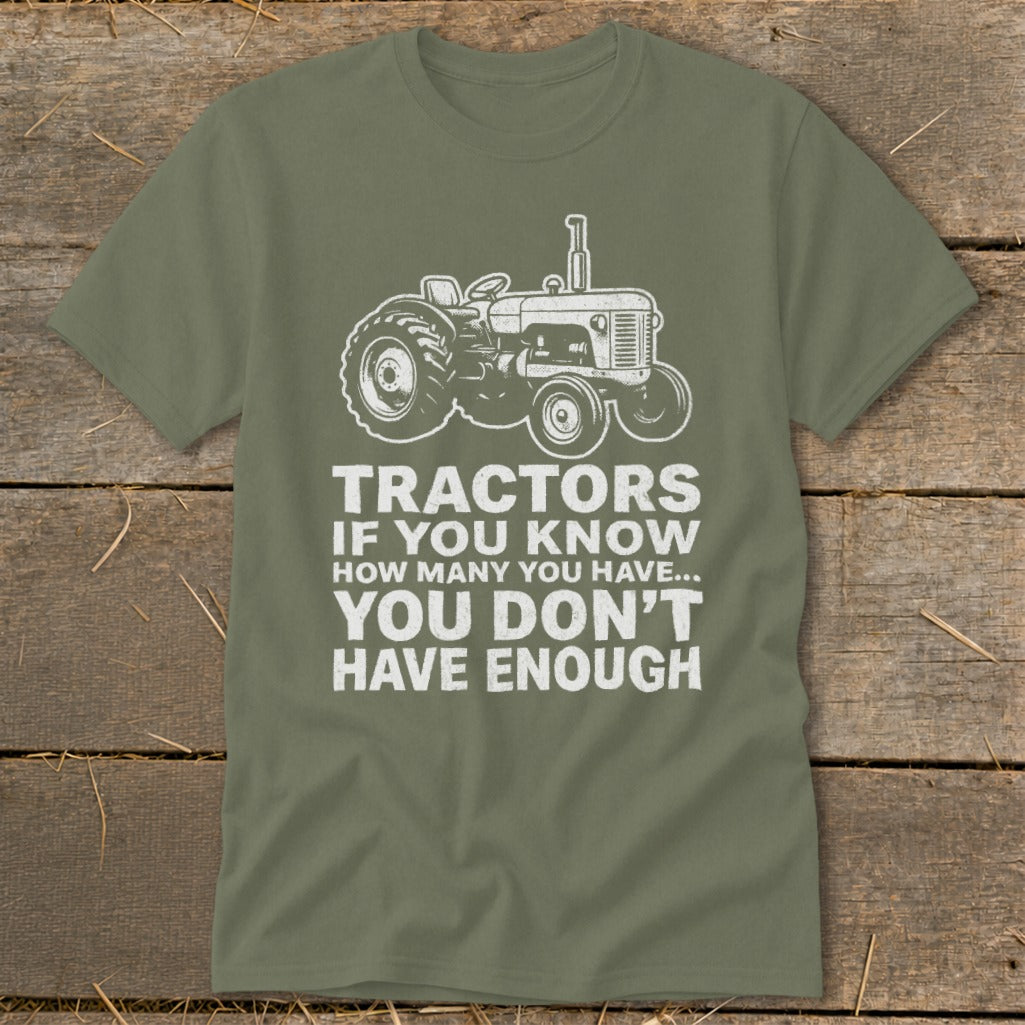 Green t-shirt with tractor graphic and text "Tractors if you know how many you have... you don't have enough".