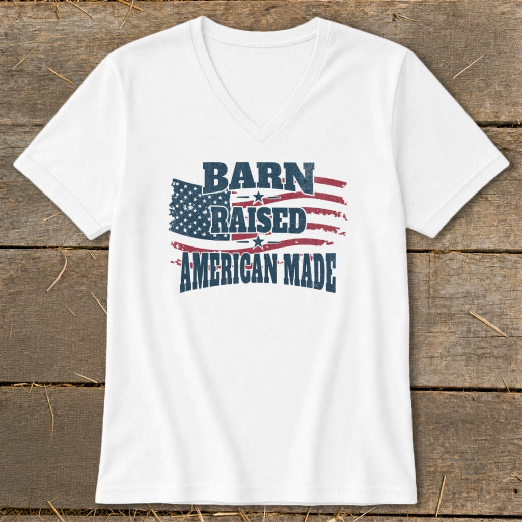 White V-neck t-shirt with distressed American flag graphic and text "BARN RAISED AMERICAN MADE".