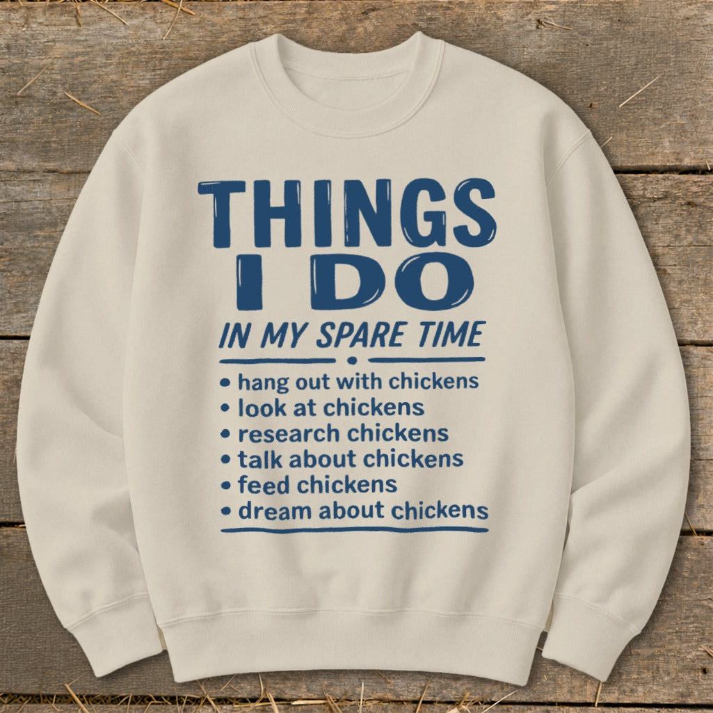 Cream sweatshirt with blue text: "THINGS I DO IN MY SPARE TIME" and chicken-related activities.
