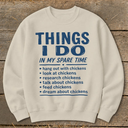 Cream sweatshirt with blue text: "THINGS I DO IN MY SPARE TIME" and chicken-related activities.