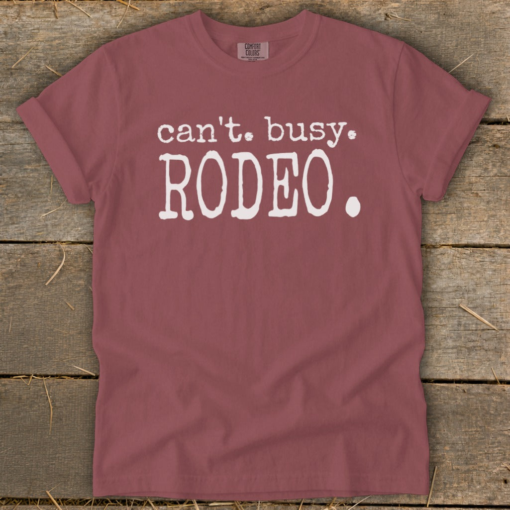 Maroon t-shirt with white text that reads "can't. busy. RODEO.".