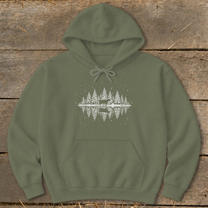 Olive green hoodie with white reflection graphic of trees, a cabin, and a cow.