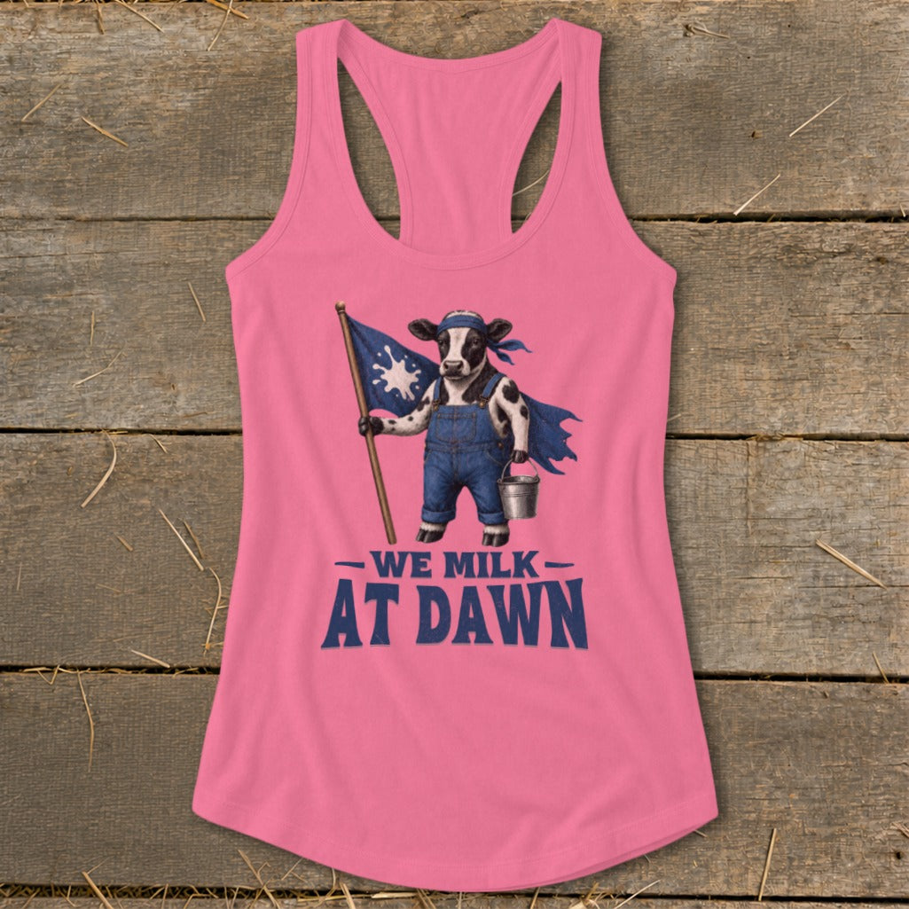Pink tank top with a cow holding a flag and bucket, text reads "WE MILK AT DAWN".