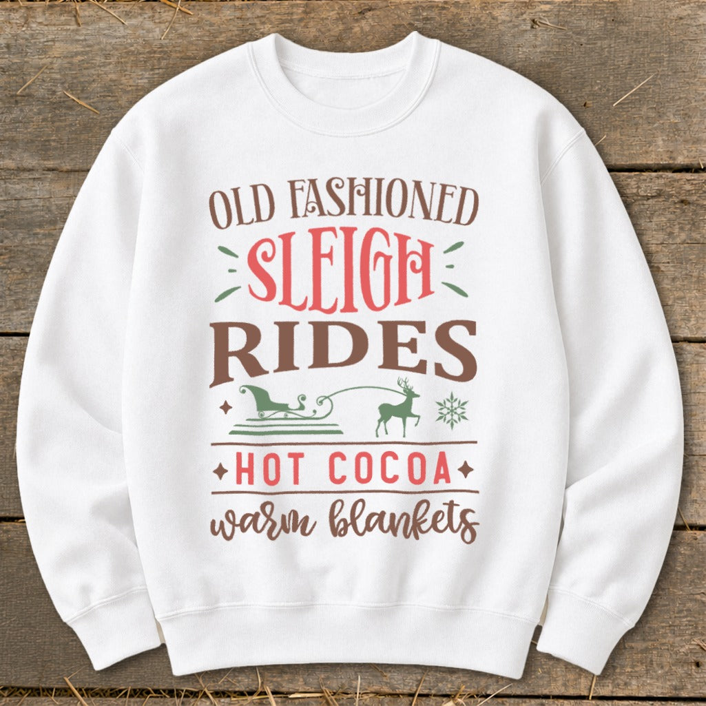 White sweatshirt with "Old Fashioned Sleigh Rides Hot Cocoa Warm Blankets" text and graphics.
