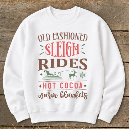 White sweatshirt with "Old Fashioned Sleigh Rides Hot Cocoa Warm Blankets" text and graphics.