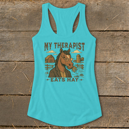 Graphic on teal tank top: Horse in suit with glasses, eating hay. Text "MY THERAPIST EATS HAY".
