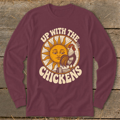 Maroon long-sleeve t-shirt with a retro graphic of a sun, a crowing rooster, and the text Up With The Chickens.