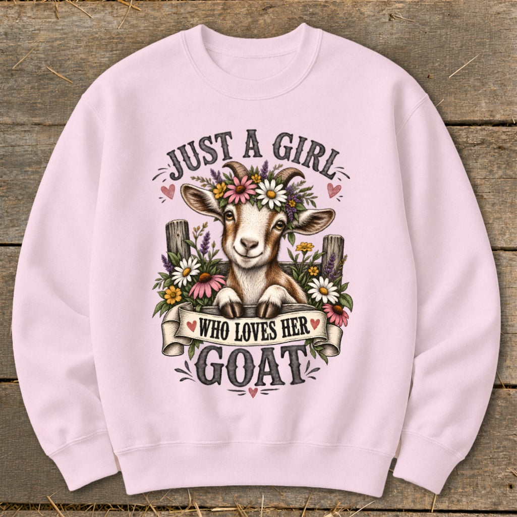 Pink sweatshirt with a smiling goat wearing a flower crown and text reading "Just a girl who loves her goat".