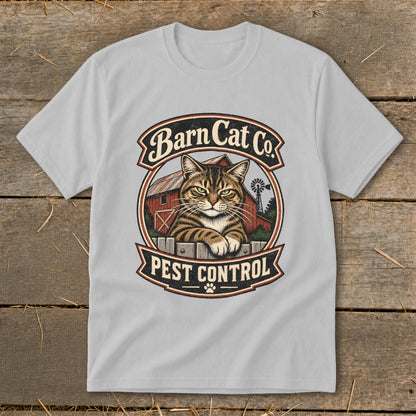 A light gray crewneck t-shirt featuring a vintage graphic of a tabby cat behind a fence with the text Barn Cat Co Pest Control.