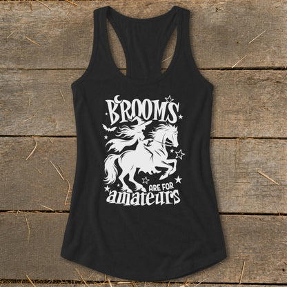 Black tank top with white graphic of witch on a horse and text "Brooms are for amateurs".