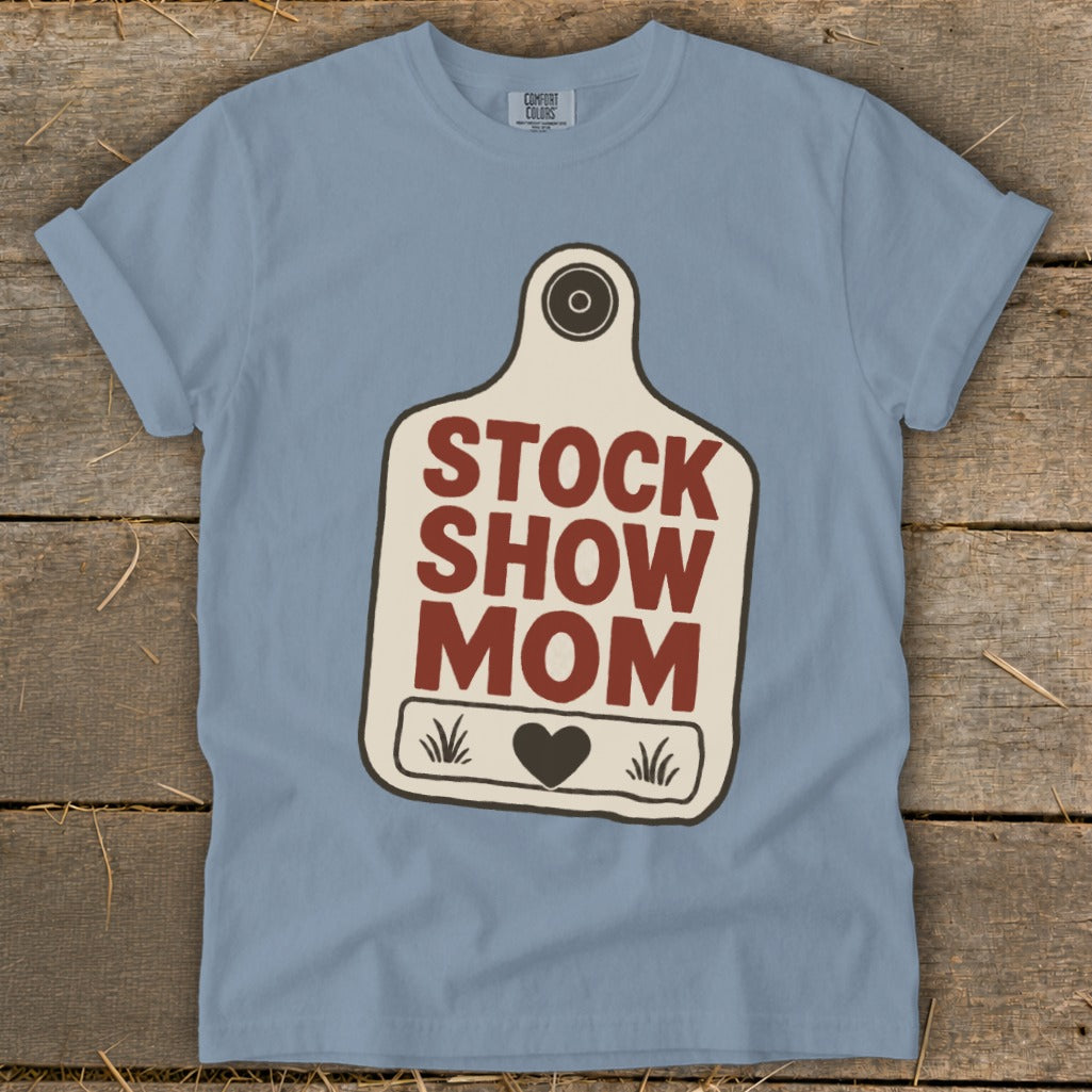 Blue t-shirt with a stock tag design reading "STOCK SHOW MOM".