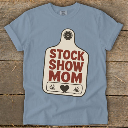 Blue t-shirt with a stock tag design reading "STOCK SHOW MOM".