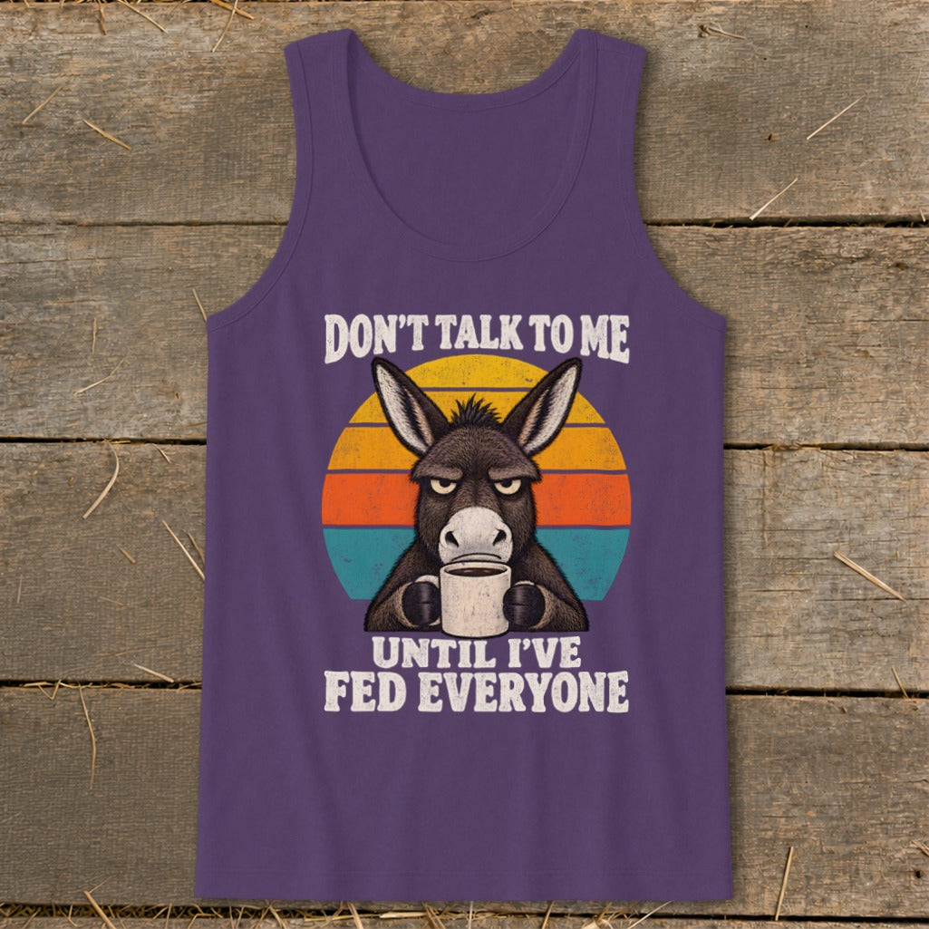 Purple tank top featuring a graphic of a grumpy donkey holding a coffee mug and text reading Don't Talk To Me Until I've Fed Everyone.