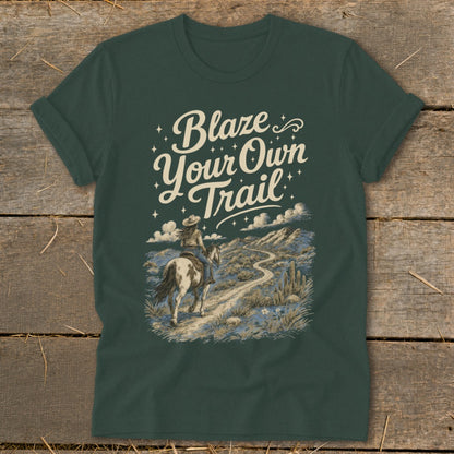 Dark green t-shirt with "Blaze Your Own Trail" graphic featuring a cowgirl on horseback.