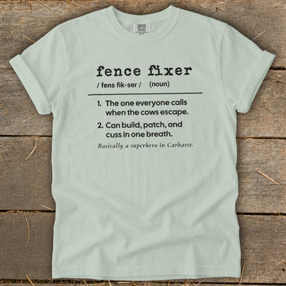 Light blue t-shirt with "fence fixer" definition: superhero who fixes fences and corrals cows.