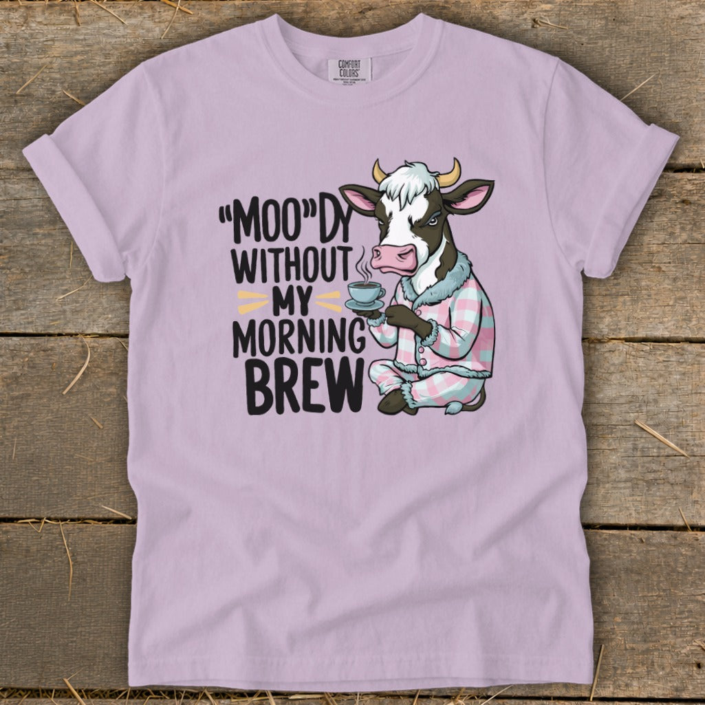 Cow in pajamas holding coffee mug with text "MOO"DY WITHOUT MY MORNING BREW.