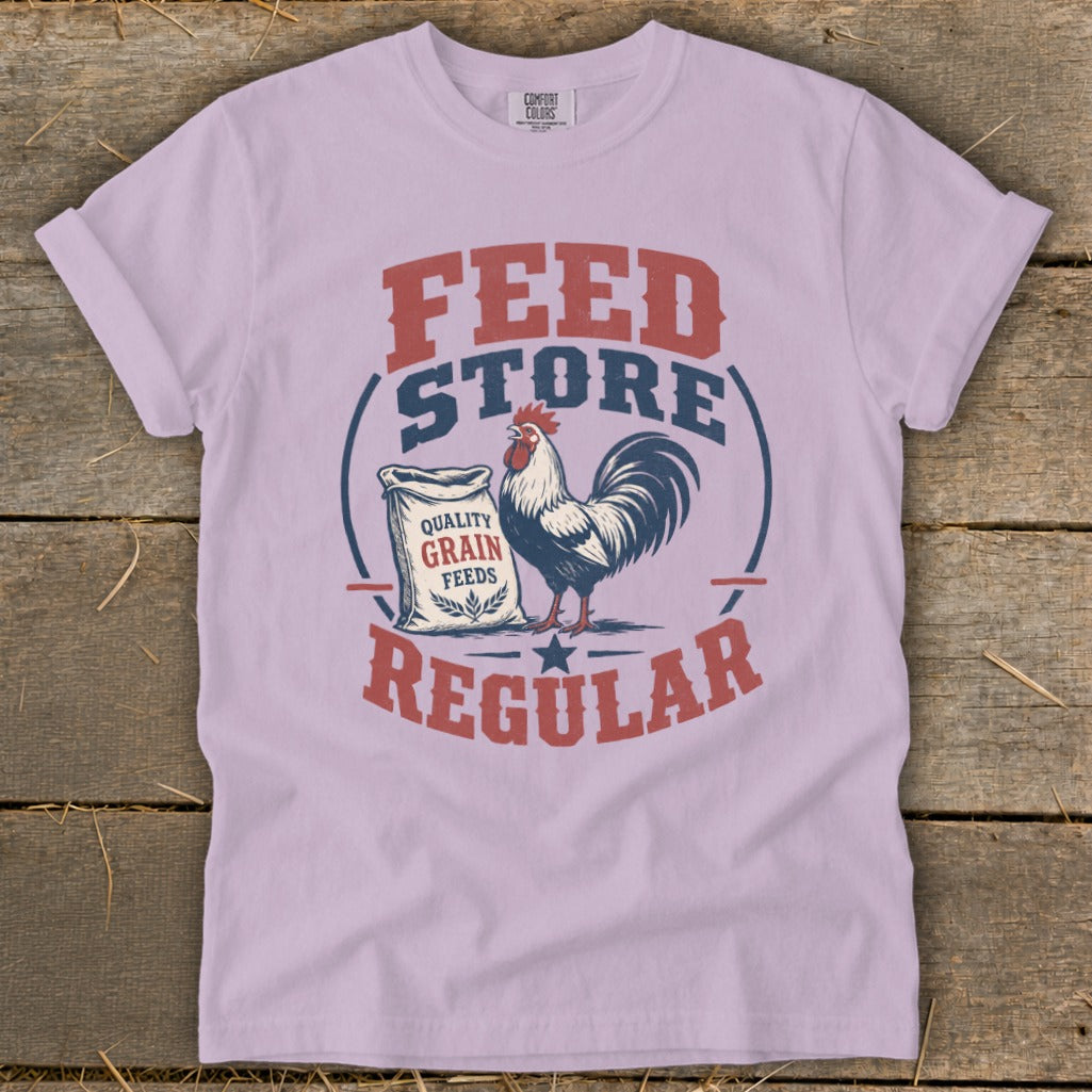 Light purple t-shirt with "Feed Store Regular" text, a rooster, and a bag of grain.