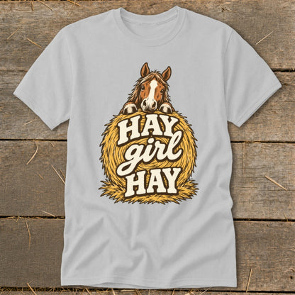 Horse peeking over hay bale with "Hay girl hay" text.