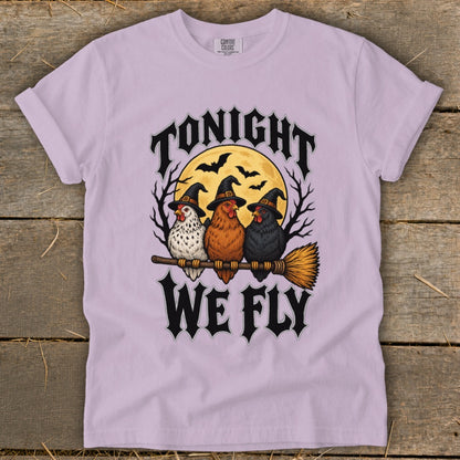 Three chickens in witch hats sit on a broomstick with text "TONIGHT WE FLY".