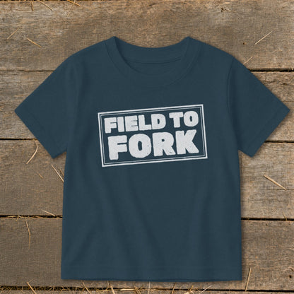 Dark blue short-sleeve t-shirt with a white rectangular border enclosing the text "FIELD TO FORK."