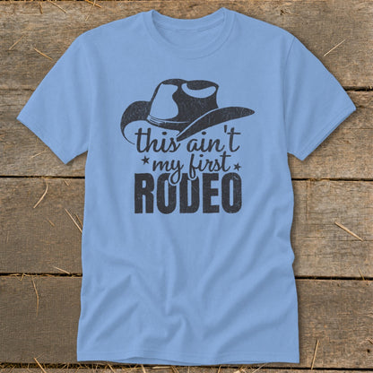 Light blue t-shirt with cowboy hat graphic and text "this ain't my first RODEO".