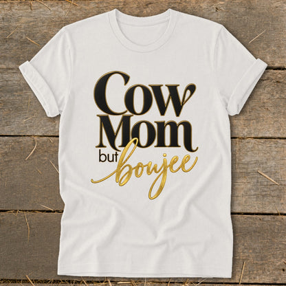 White t-shirt with "Cow Mom but boujee" text in black and gold.